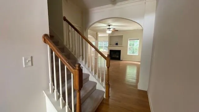 a view of an empty room with a fireplace and a window