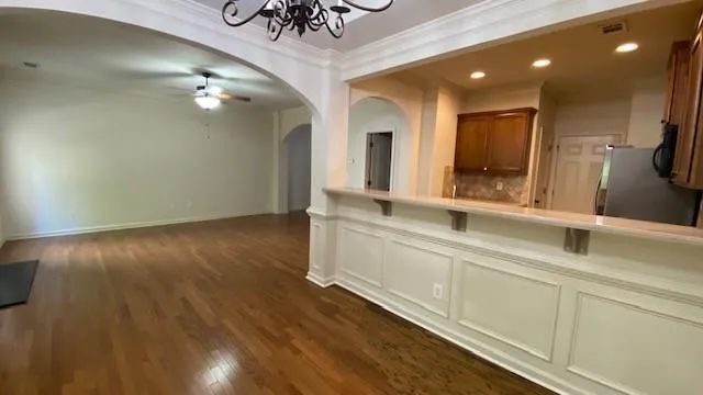 a kitchen with stainless steel appliances granite countertop a refrigerator a stove and a sink