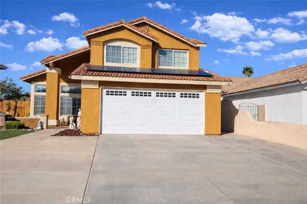a view of house with garage and small yard