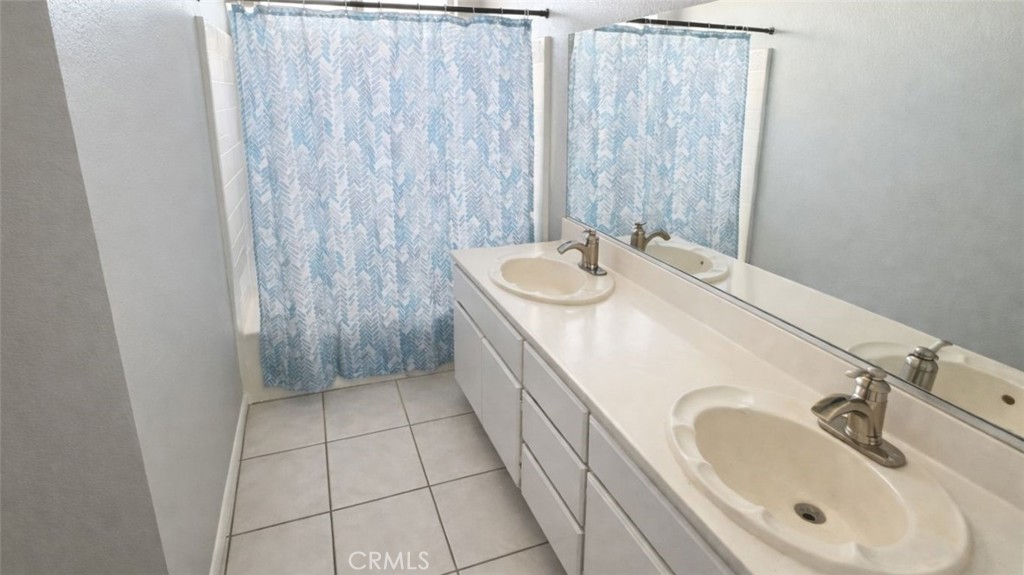 19972 Windwood Circle Riverside, CA 92508 - Photo 13 of 17 a bathroom with a sink and a mirror