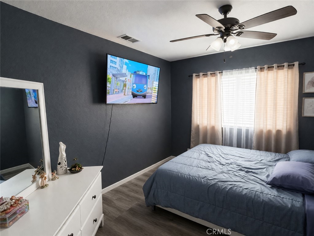 19972 Windwood Circle Riverside, CA 92508 - Photo 16 of 17 a bedroom with a bed and a flat screen tv