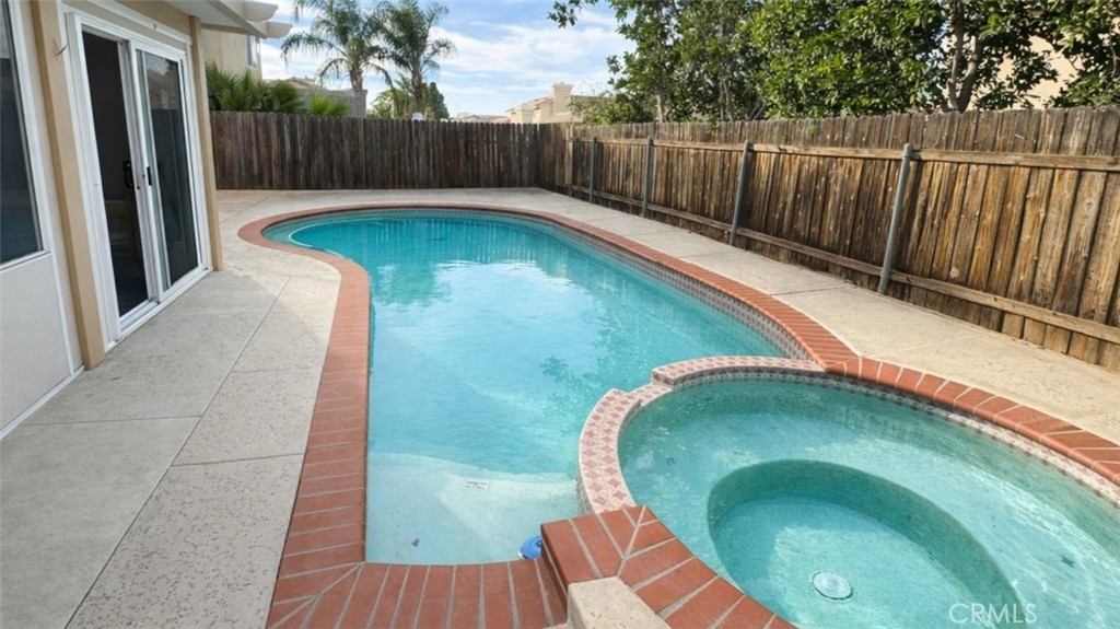 19972 Windwood Circle Riverside, CA 92508 - Photo 9 of 17 a swimming pool with wooden fence