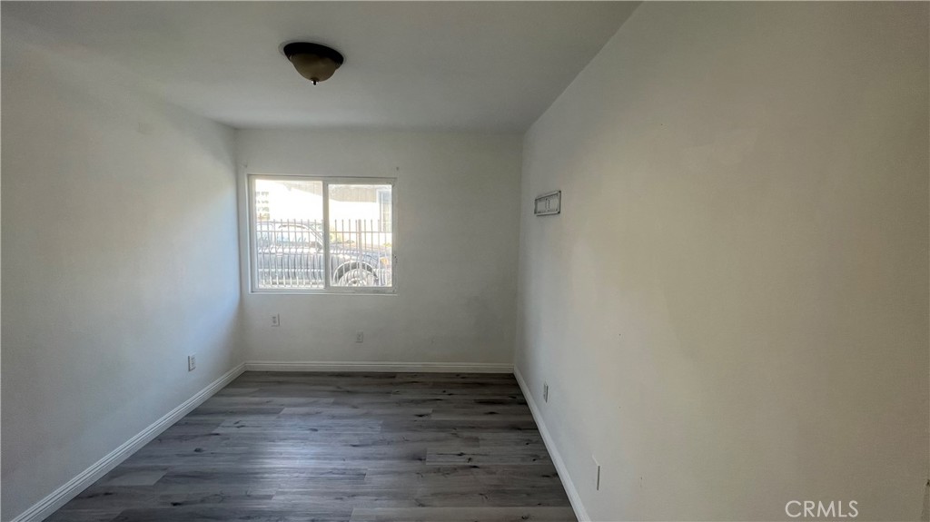 1582 Ricardo Street Los Angeles, CA 90033 - Photo 22 of 27 an empty room with wooden floor and windows