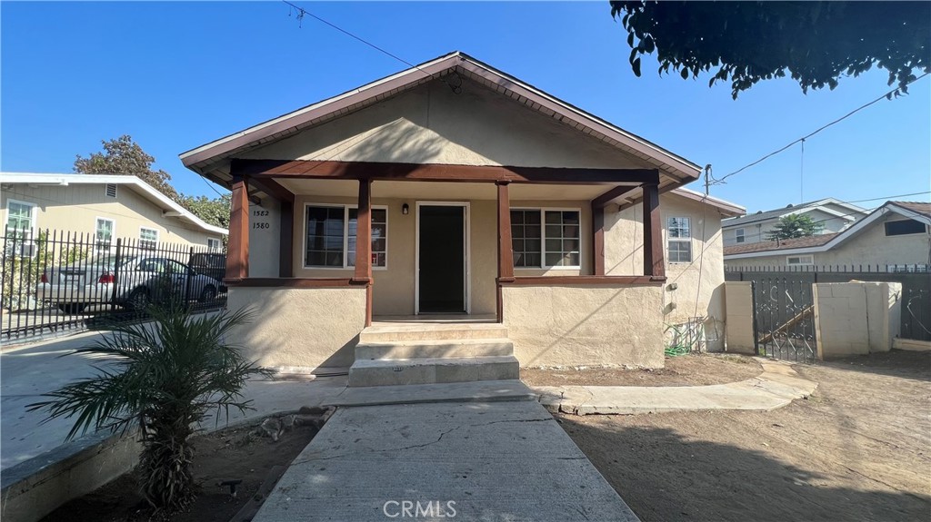 1582 Ricardo Street Los Angeles, CA 90033 - Photo 3 of 27 a view of a white house with a small yard and plants