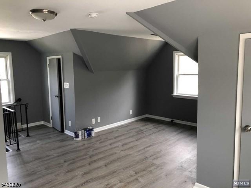 166 Carmita Avenue Rutherford, NJ 07070 - Photo 24 of 27 an empty room with wooden floor and windows