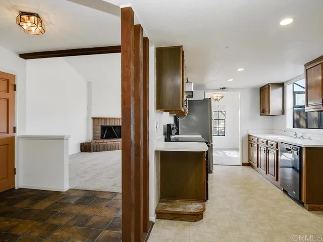 a kitchen with stainless steel appliances kitchen island granite countertop a refrigerator and a stove