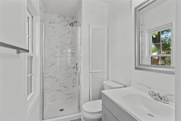 a bathroom with a sink toilet and shower