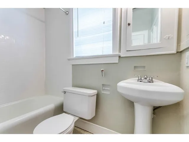 a bathroom with a sink a toilet and bathtub