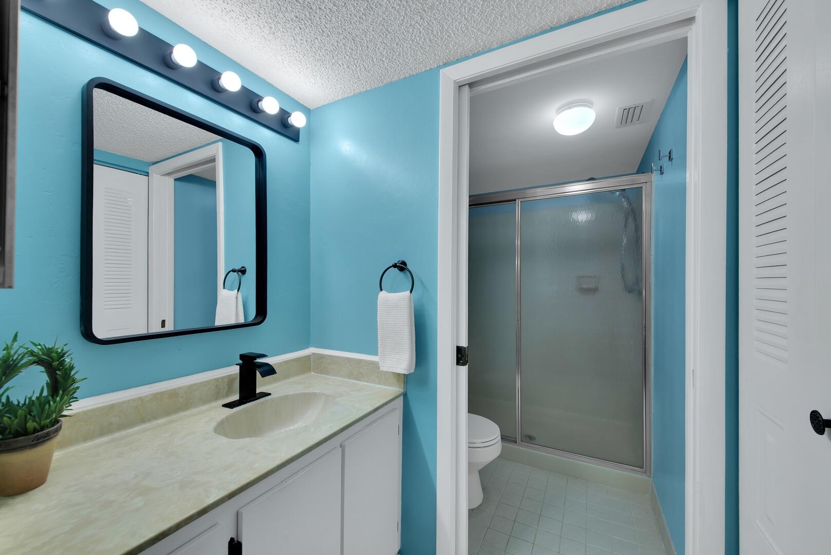 4708 Lucerne Lakes Boulevard East, Unit 104 Lake Worth, FL 33467 - Photo 17 of 28 a bathroom with a toilet a sink and mirror