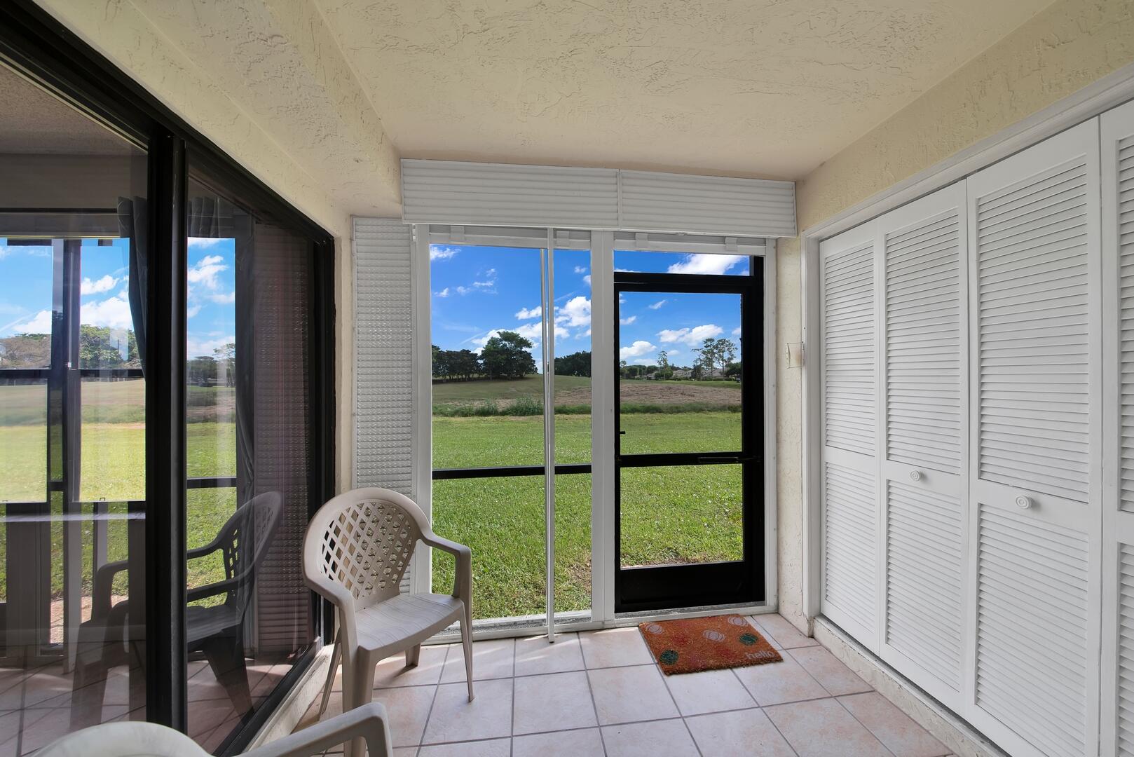 4708 Lucerne Lakes Boulevard East, Unit 104 Lake Worth, FL 33467 - Photo 21 of 28 a view of a porch with chairs and backyard