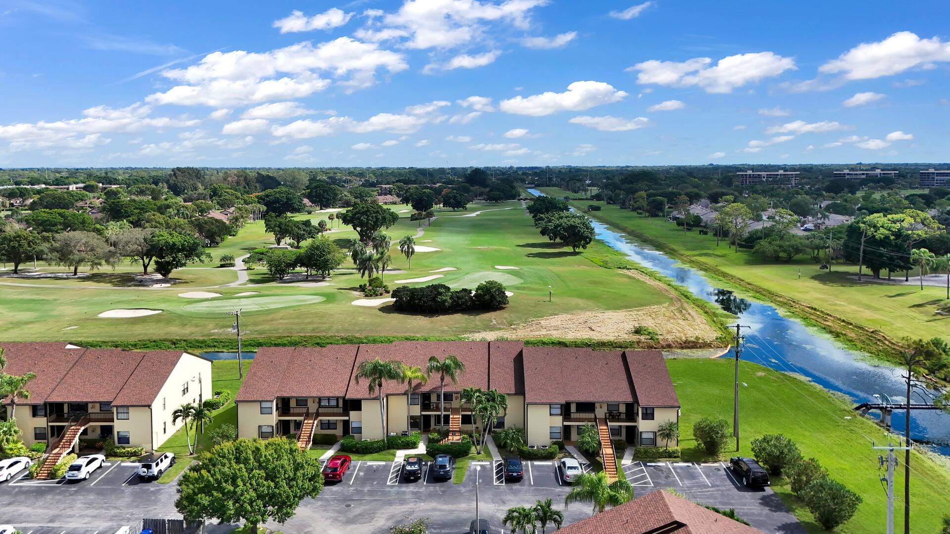 4708 Lucerne Lakes Boulevard East, Unit 104 Lake Worth, FL 33467 - Photo 24 of 28 an aerial view of a house with a garden