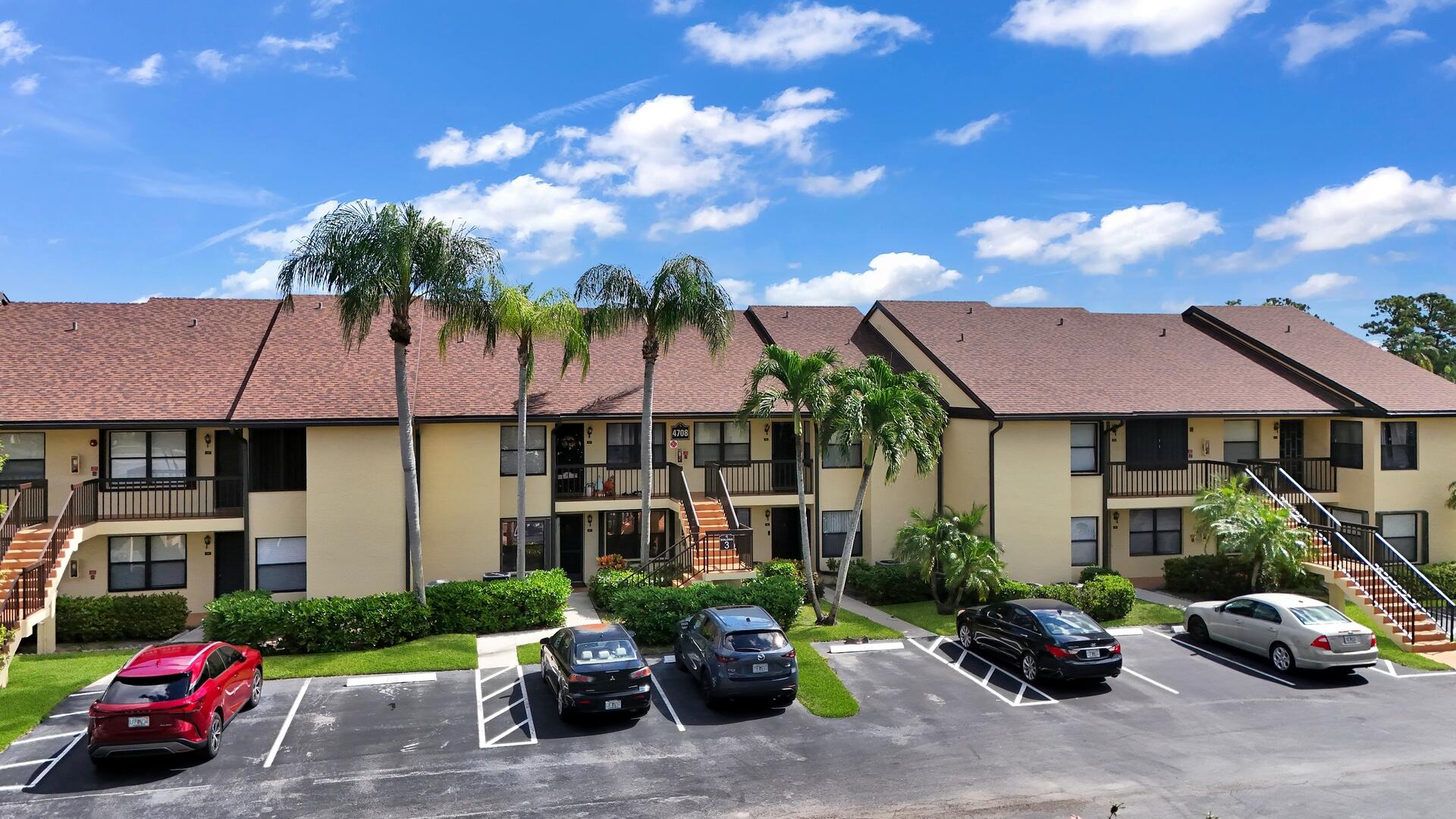 4708 Lucerne Lakes Boulevard East, Unit 104 Lake Worth, FL 33467 - Photo 25 of 28 a car parked in front of a house