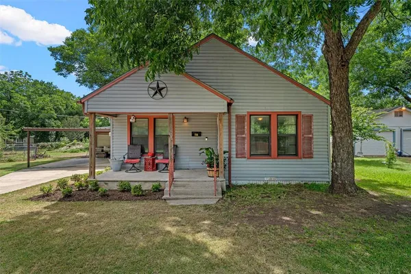 a view of house with backyard and deck