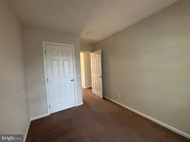 a view of an empty room and closet area