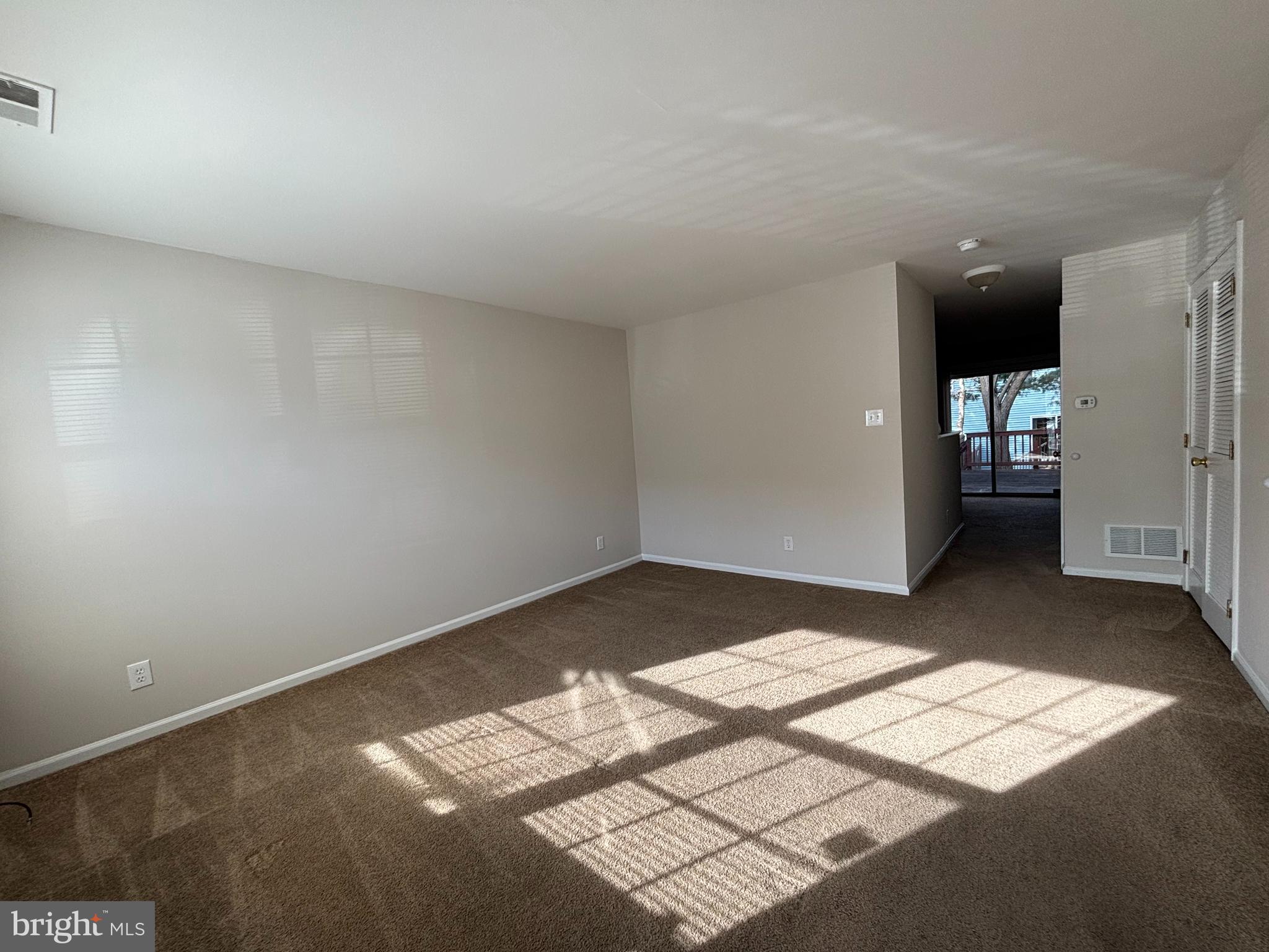 27 Gristmill Lane Pine Hill, NJ 08021 - Photo 3 of 19 a view of wooden floor and windows in an empty room