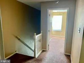 a view of a hallway with a door