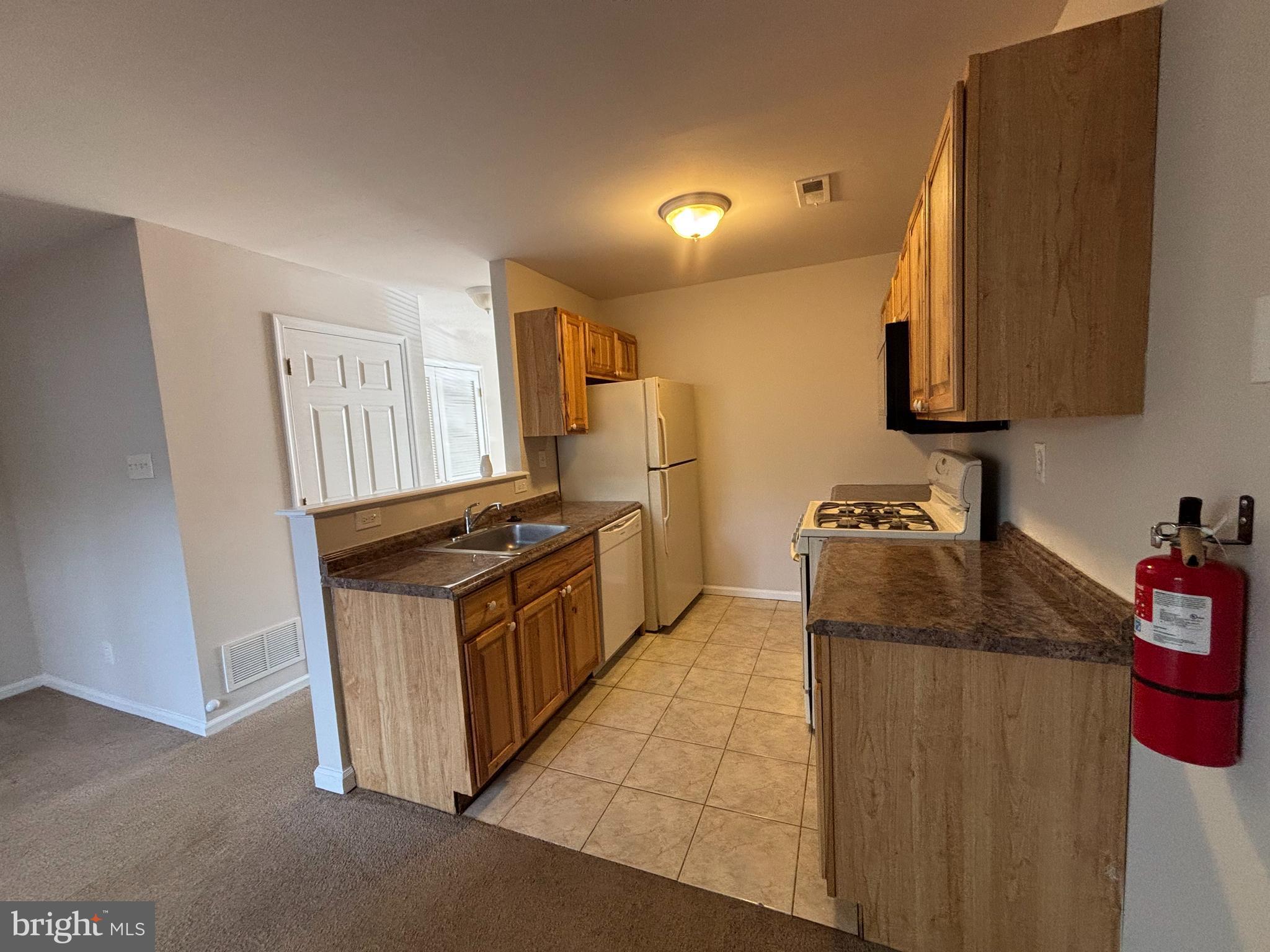 27 Gristmill Lane Pine Hill, NJ 08021 - Photo 4 of 19 a kitchen with granite countertop a stove and a sink