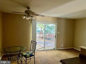 a view of a room with a table and chairs