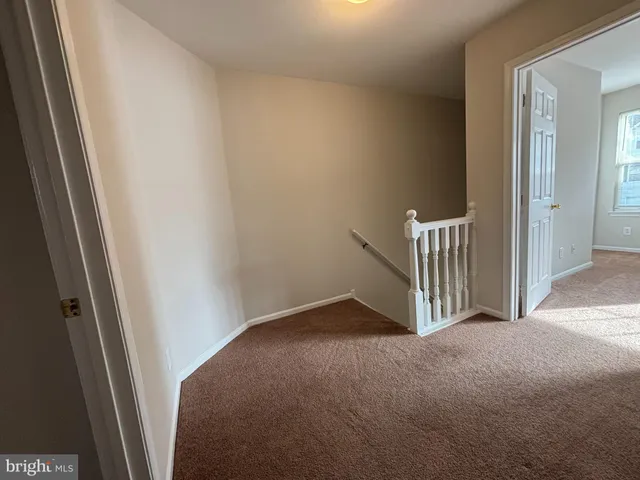 a view of a hallway and closet in a room