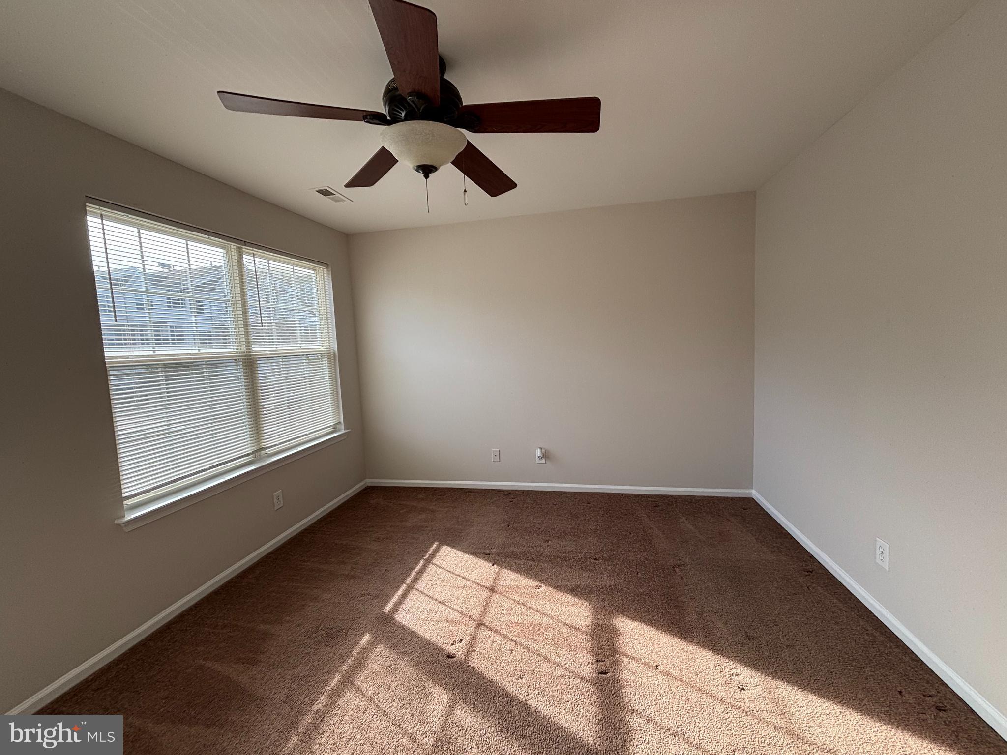 27 Gristmill Lane Pine Hill, NJ 08021 - Photo 9 of 19 an empty room with windows and ceiling fan