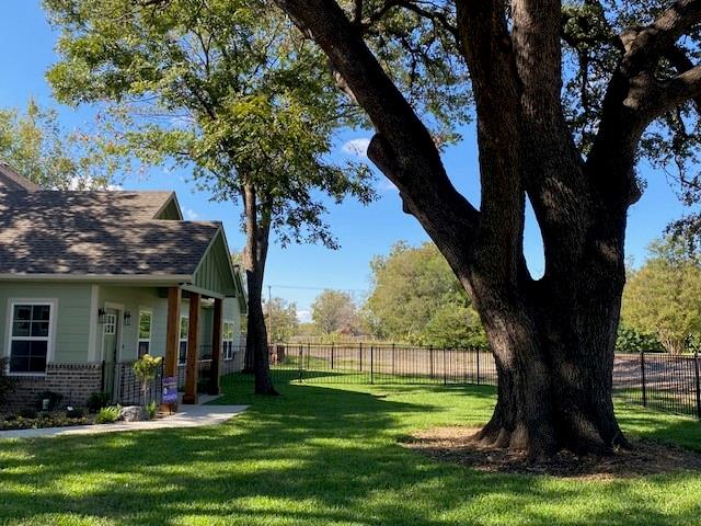 403 South 6th Street, Unit B Midlothian, TX 76065 - Photo 2 of 9 a view of a backyard with table and chairs and a large tree