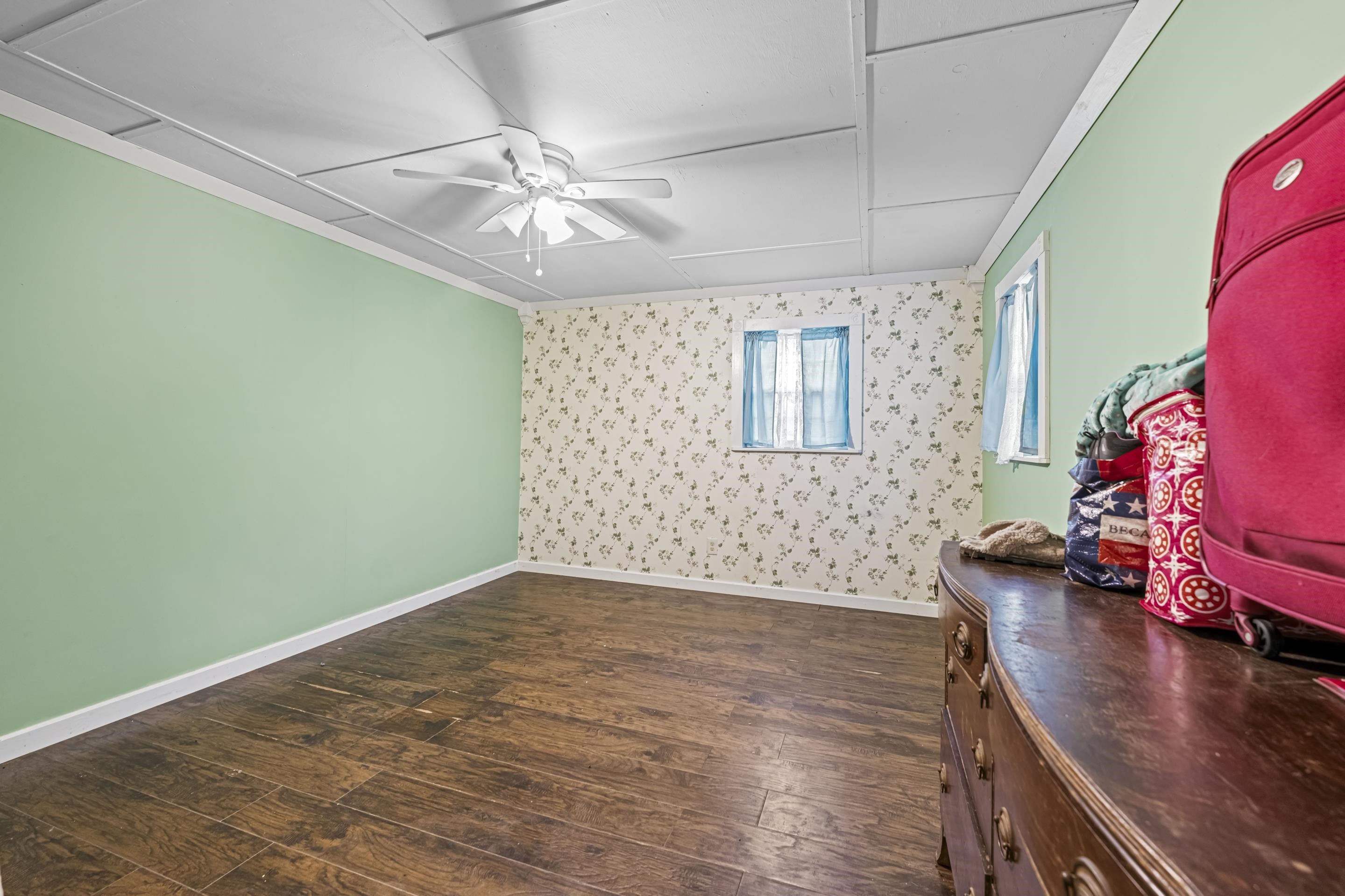 754 McWilliams Road Covington, TN 38019 - Photo 17 of 28 a view of an empty room with window and wooden floor