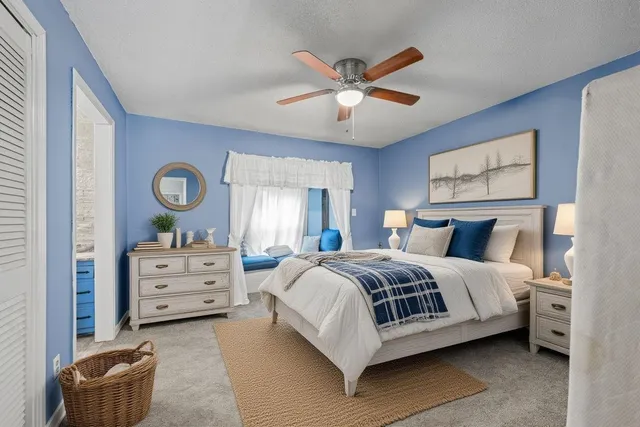 an empty room with closet and fan