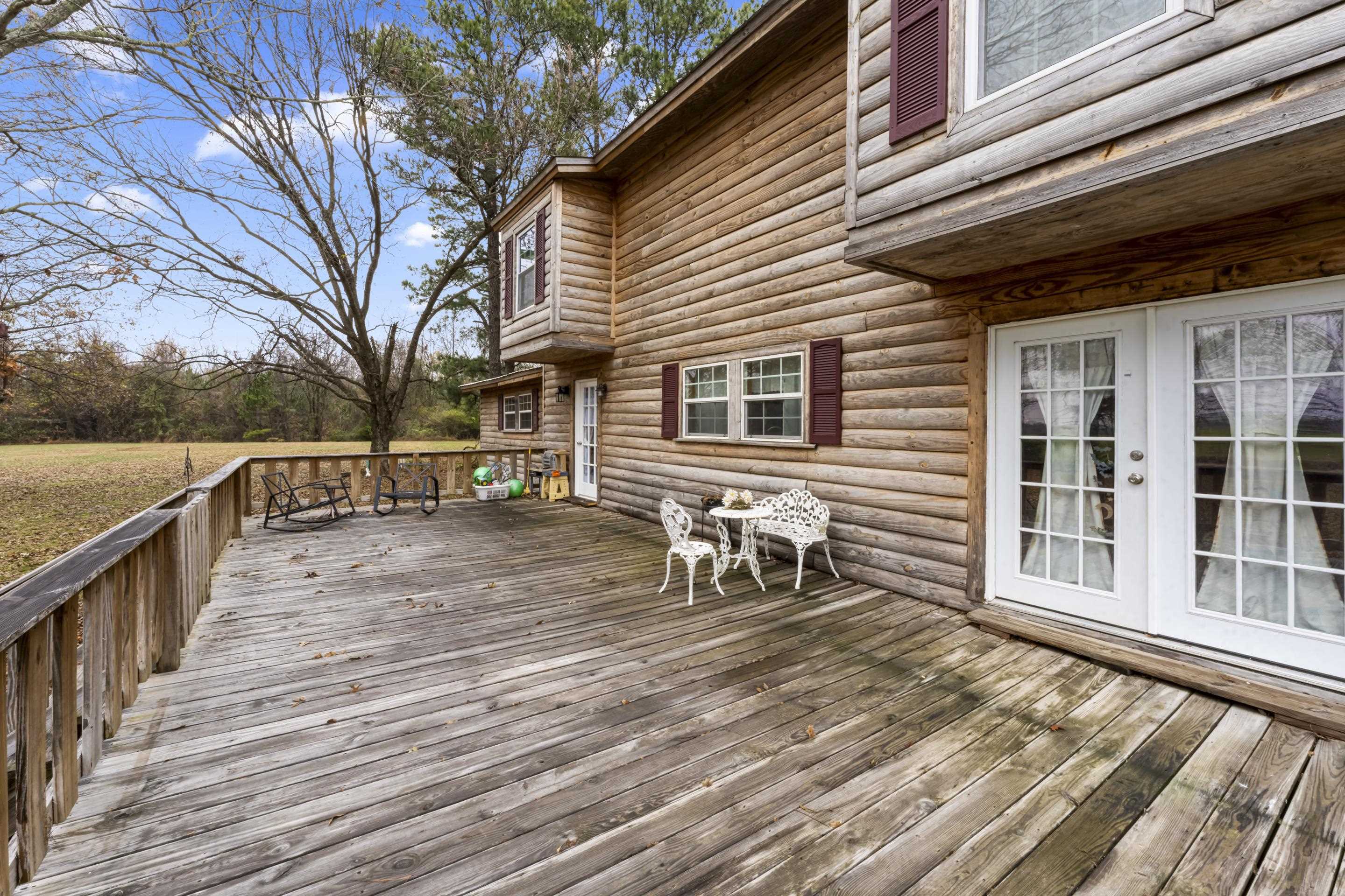 754 McWilliams Road Covington, TN 38019 - Photo 26 of 28 a view of a house with wooden deck and furniture