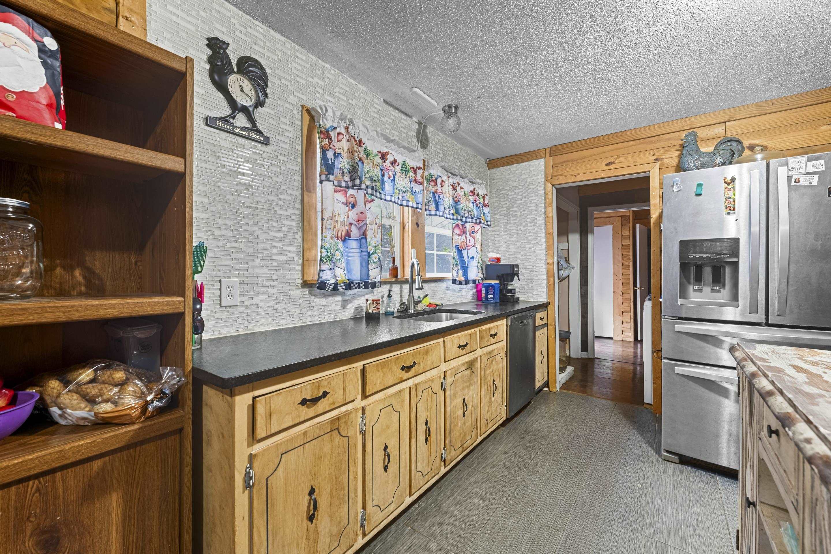 754 McWilliams Road Covington, TN 38019 - Photo 7 of 28 a kitchen with stainless steel appliances granite countertop a lot of counter top space
