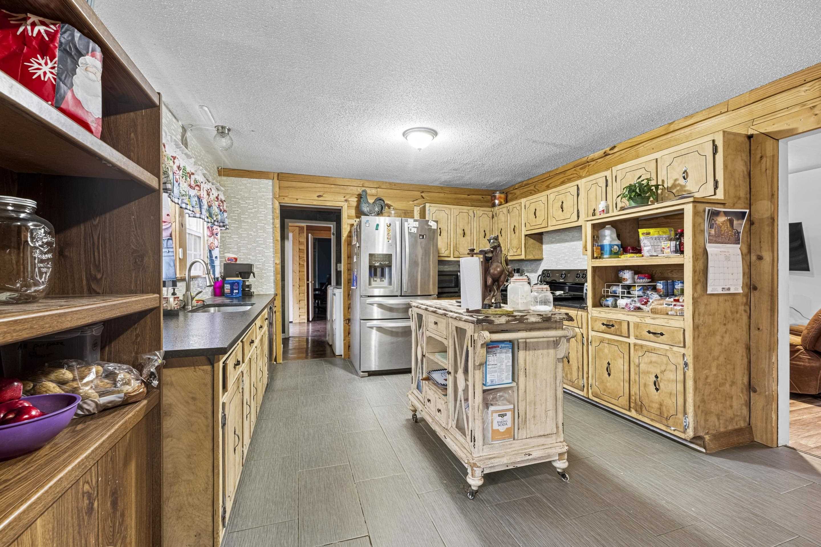 754 McWilliams Road Covington, TN 38019 - Photo 8 of 28 a kitchen with stainless steel appliances kitchen island granite countertop a stove and cabinets