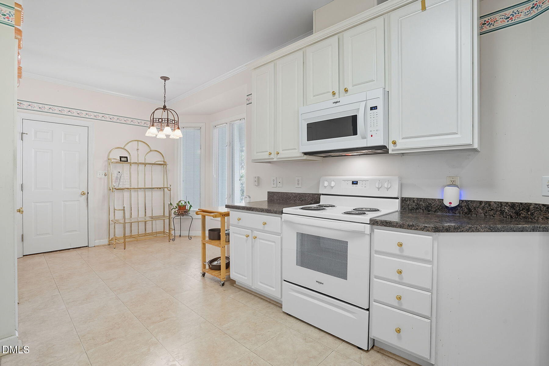 2029 Castle Pines Drive Raleigh, NC 27604 - Photo 17 of 38 a kitchen with white cabinets and white appliances