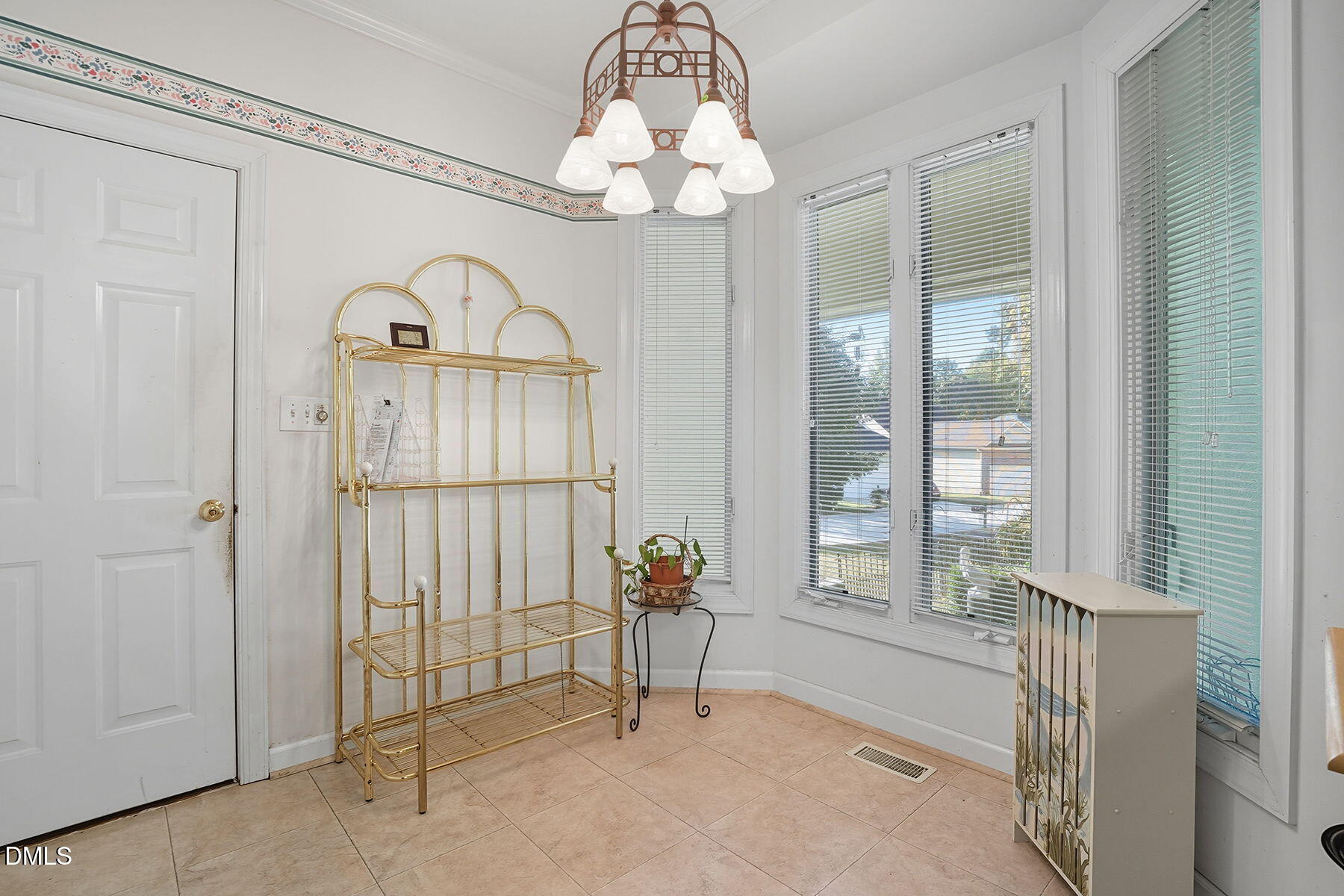 2029 Castle Pines Drive Raleigh, NC 27604 - Photo 19 of 38 a view of a hallway with windows and chandelier