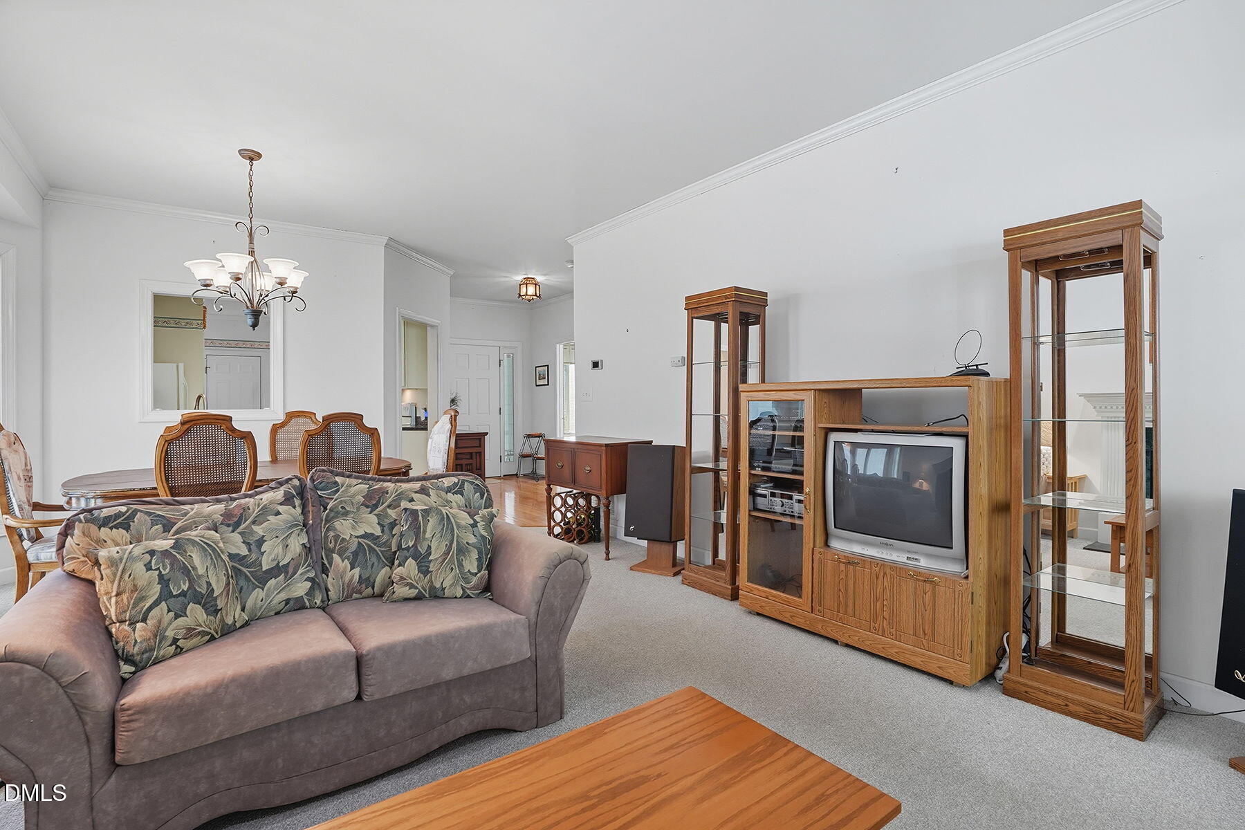 2029 Castle Pines Drive Raleigh, NC 27604 - Photo 9 of 38 a living room with furniture and a chandelier