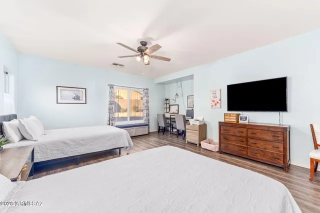 a bedroom with a bed and a flat screen tv