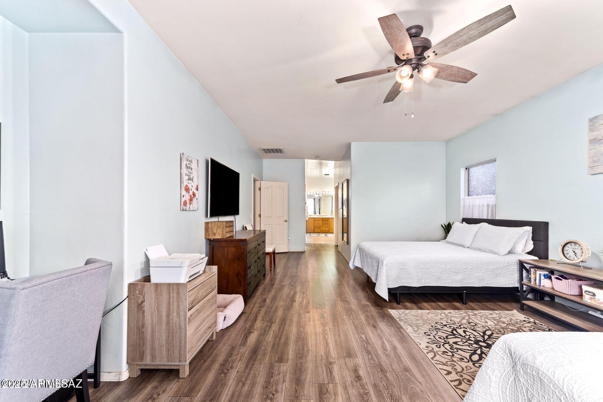 3635 East Secretariat Road Tucson, AZ 85739 - Photo 13 of 27 a spacious bedroom with a bed and wooden floor