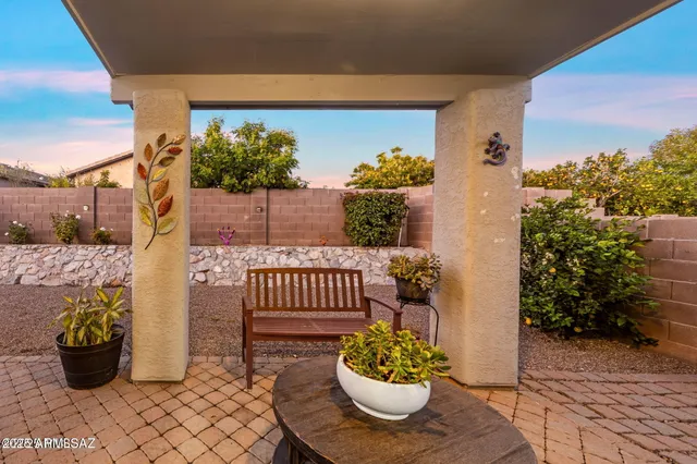 a view of a porch with dining table and chairs potted plants