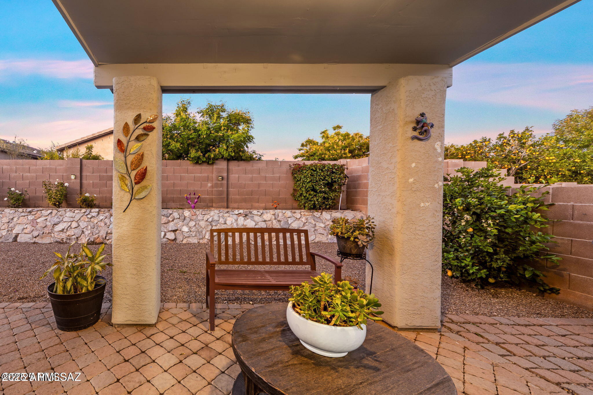3635 East Secretariat Road Tucson, AZ 85739 - Photo 20 of 27 a view of a porch with dining table and chairs potted plants