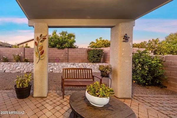 a view of a porch with dining table and chairs potted plants