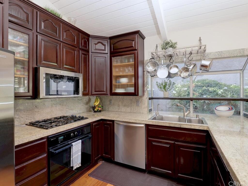7 Sunridge Irvine, CA 92604 - Photo 13 of 66 a kitchen with stainless steel appliances granite countertop a stove and a sink