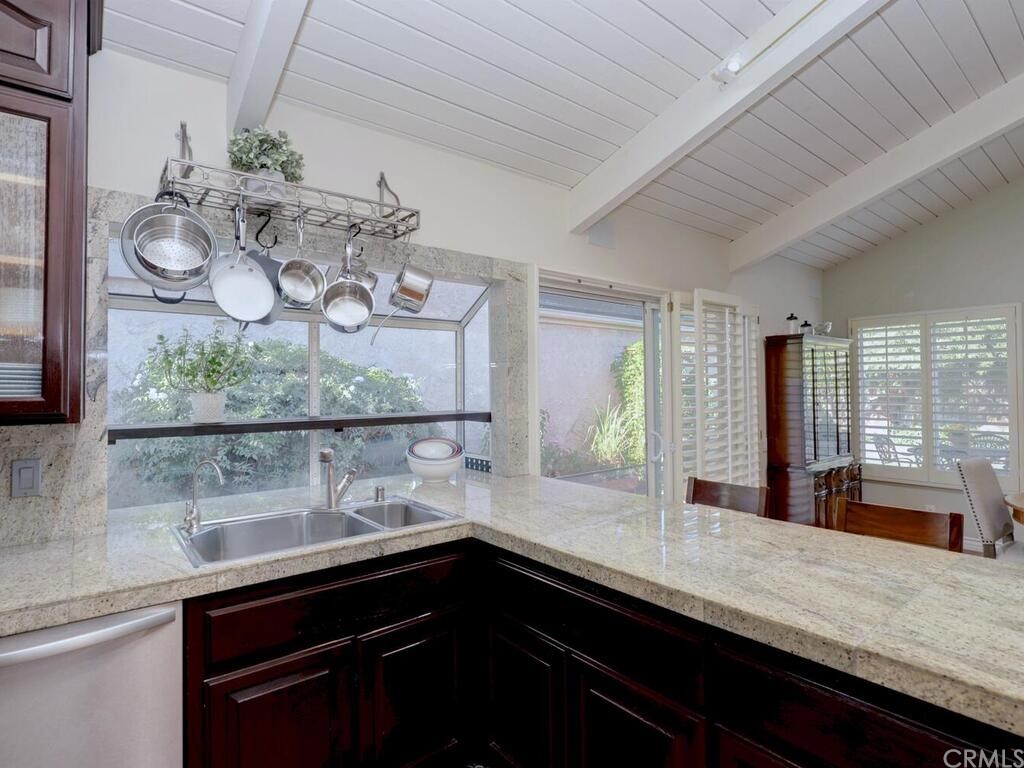 7 Sunridge Irvine, CA 92604 - Photo 14 of 66 a kitchen with stainless steel appliances a sink and a large window