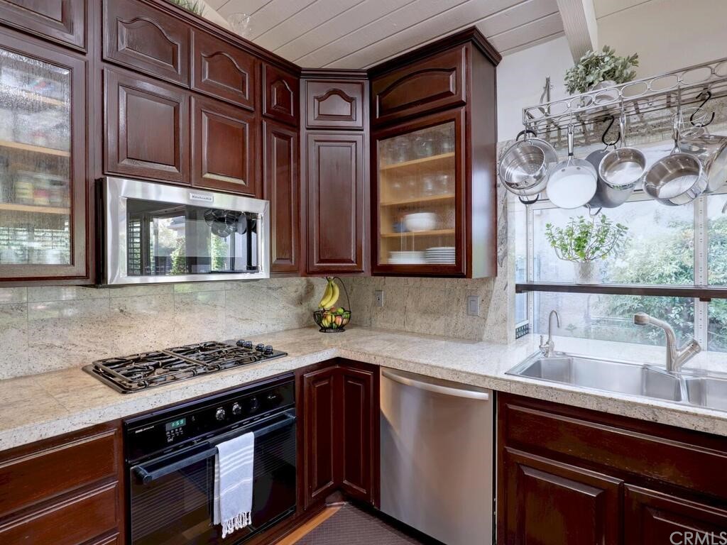 7 Sunridge Irvine, CA 92604 - Photo 16 of 66 a kitchen with stainless steel appliances granite countertop a sink stove and cabinets