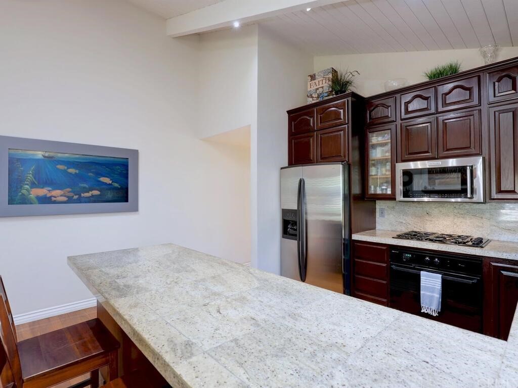 7 Sunridge Irvine, CA 92604 - Photo 17 of 66 a kitchen with stainless steel appliances granite countertop a refrigerator and a stove top oven