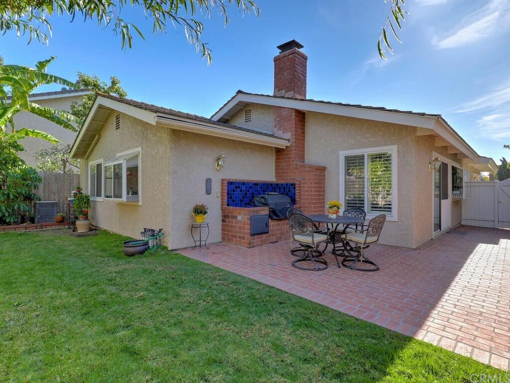 7 Sunridge Irvine, CA 92604 - Photo 2 of 66 a view of a backyard with table and chairs under an umbrella