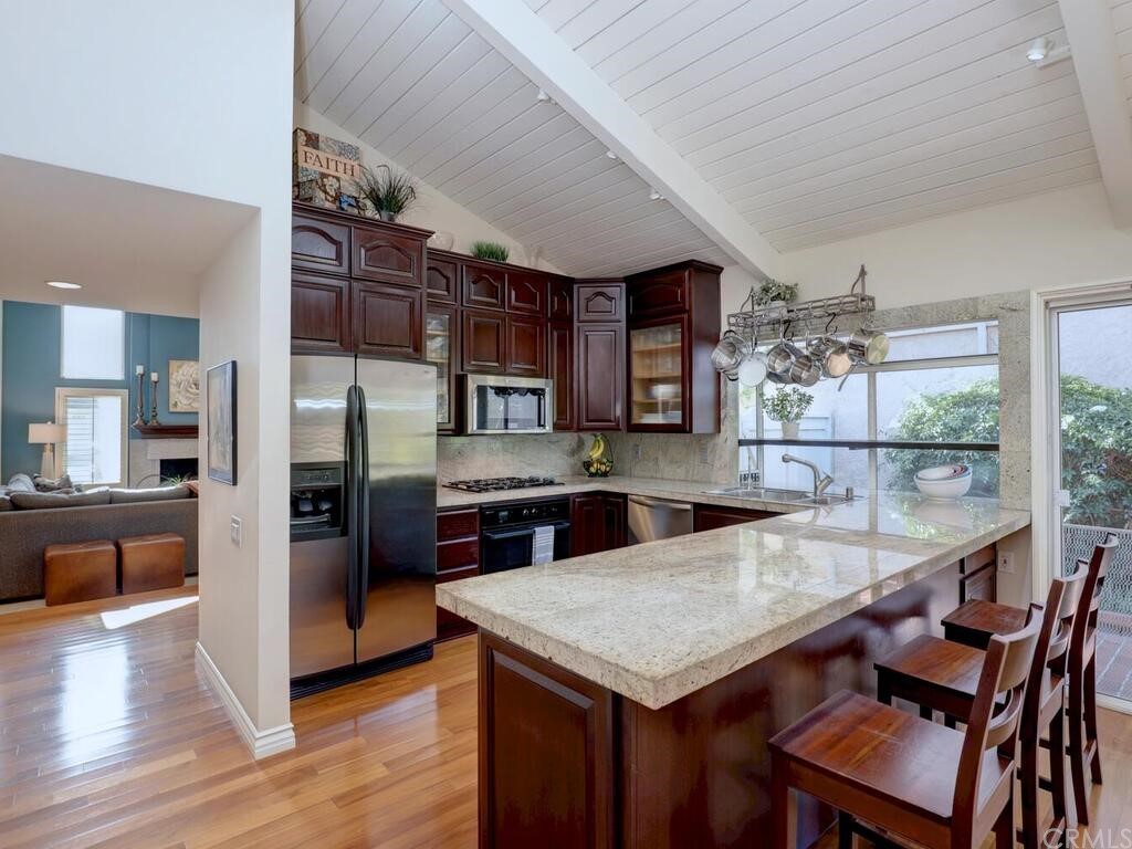 7 Sunridge Irvine, CA 92604 - Photo 66 of 66 a kitchen with stainless steel appliances granite countertop a sink cabinets and wooden floor