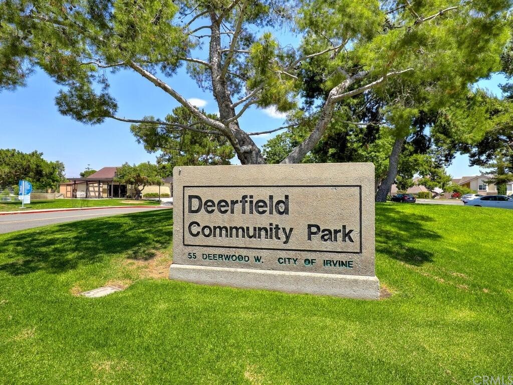 7 Sunridge Irvine, CA 92604 - Photo 46 of 66 a sign of golf club on a wall under a tree