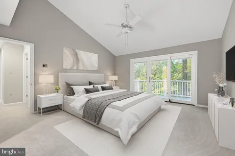 a large bedroom with a bed and large window