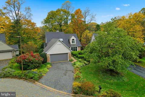 a front view of a house with a yard and fountain in middle