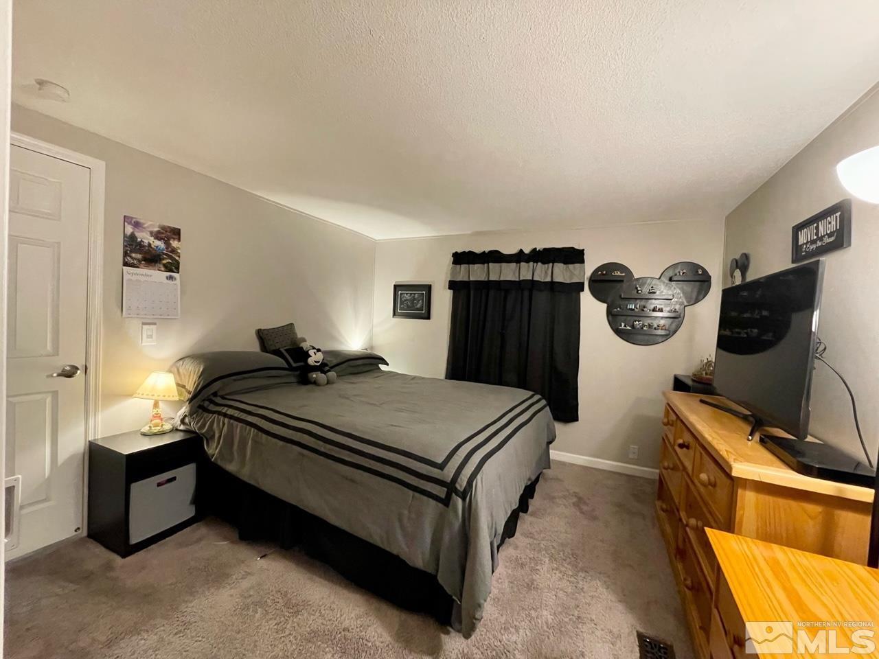 2197 Barberry Way Reno, NV 89512 - Photo 12 of 18 a bedroom with bed and a flat tv screen on the dresser