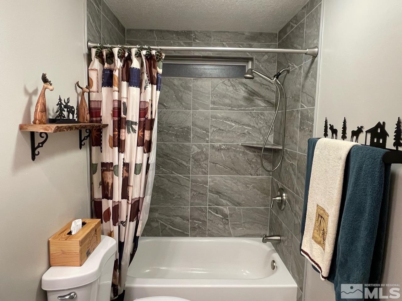 2197 Barberry Way Reno, NV 89512 - Photo 8 of 18 a bathroom with a shower and a toilet