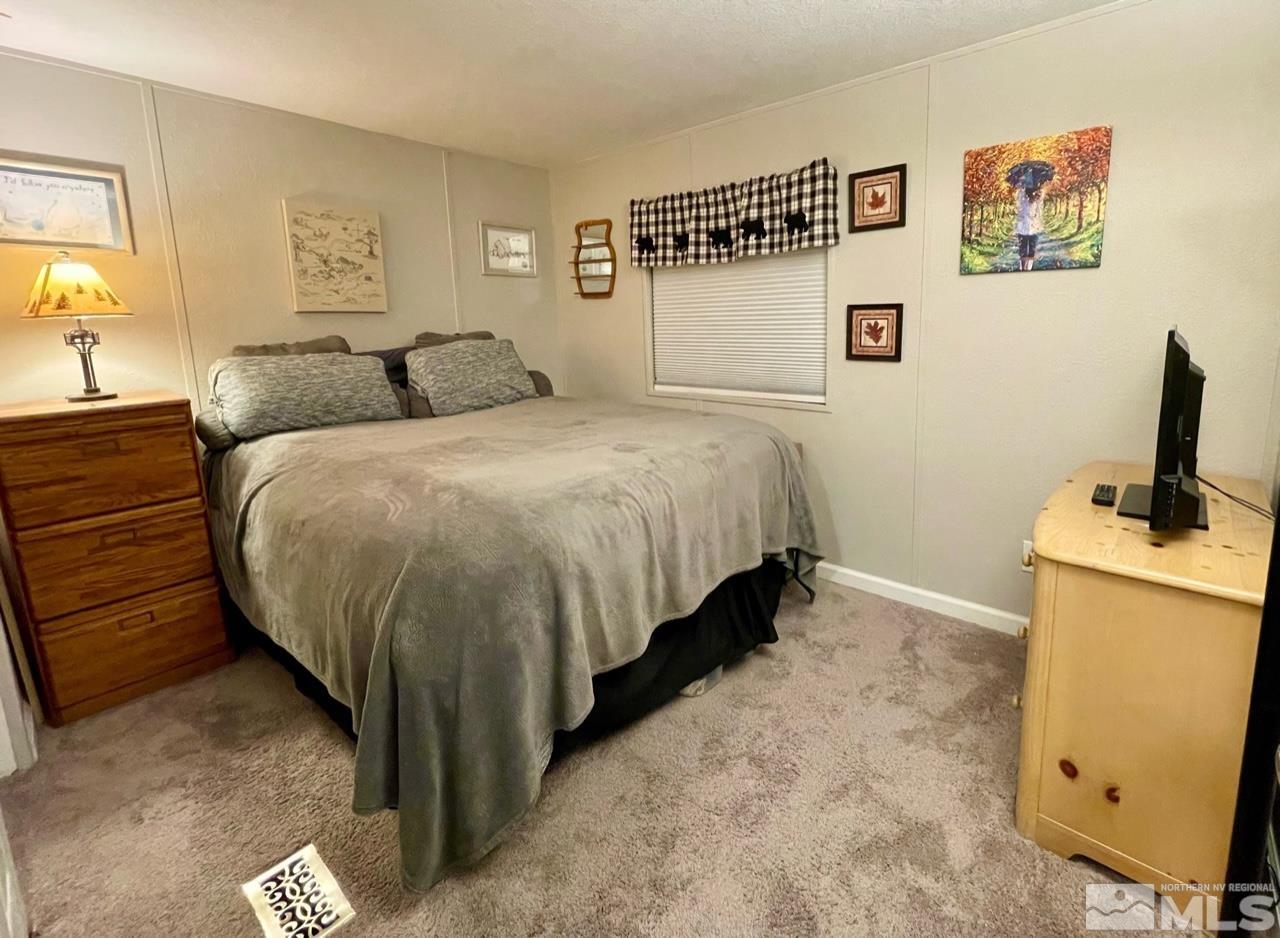 2197 Barberry Way Reno, NV 89512 - Photo 9 of 18 a bed room with a bed and a television